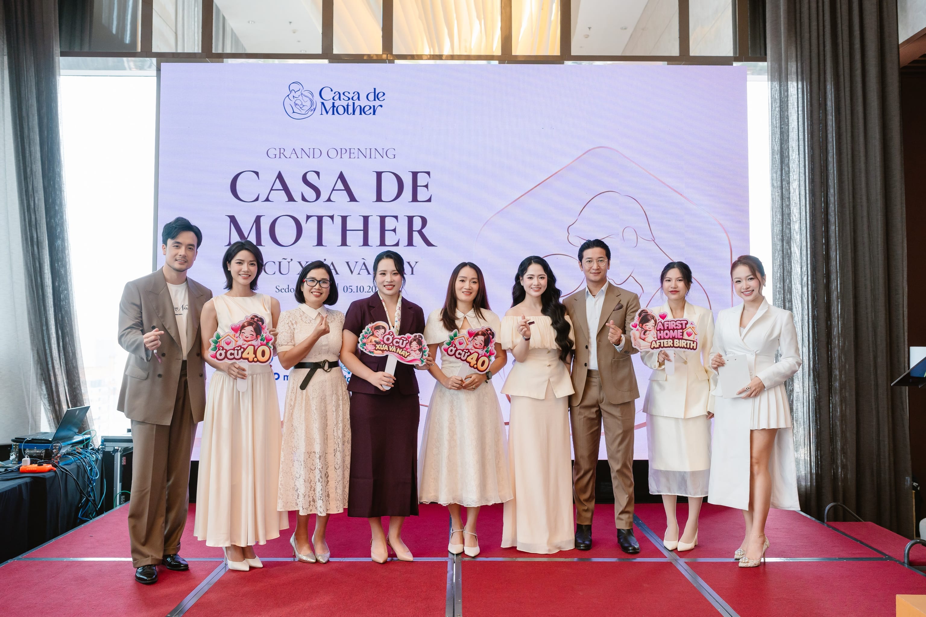 Actors Anh Đào (far left) and Việt Hoa (third and fourth from right), with their husbands, tour the confinement suite as they prepare to welcome a new family member.